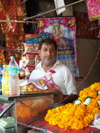 Shop owner in his market stand, Delhi
