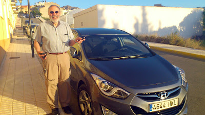 Back at the apartment with our new car - Stuart posing!