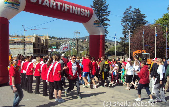 The crowd follows the MS flag to begin their fundraising walk with the Kamloops royalty cheering them on.