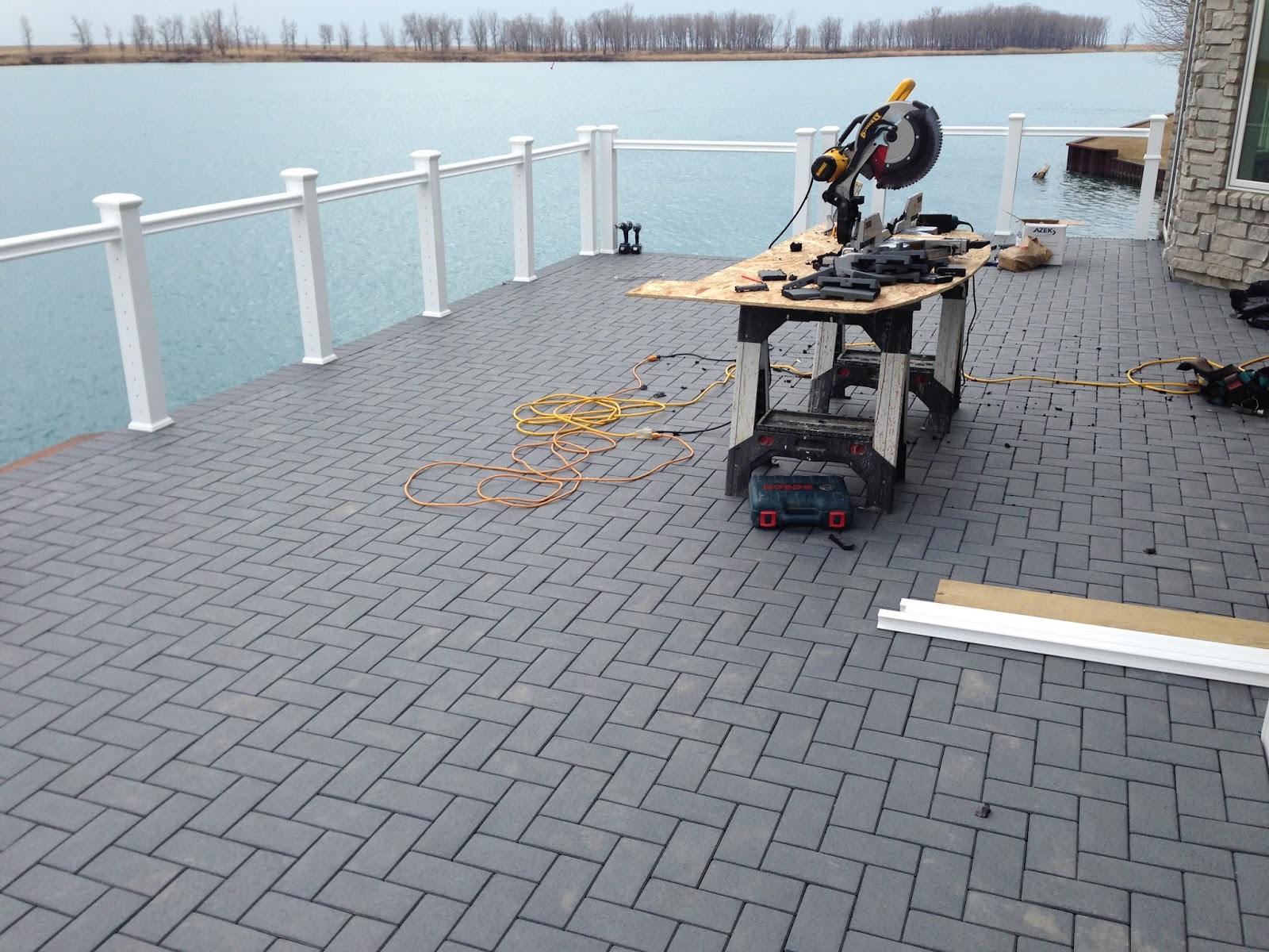 Outdoor Living Low sloped roof decks, composite pavers and cable rail.