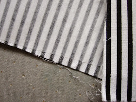 Piece of black and white striped fabric, backed with fusible webbing.
