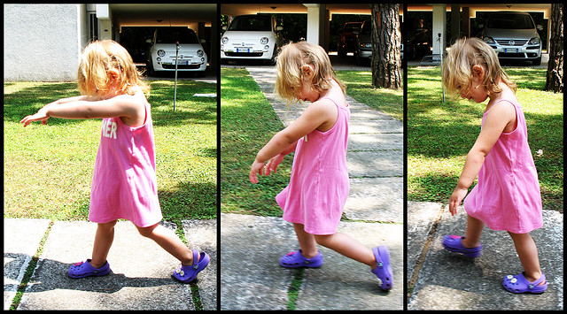 A young girl shuffling like a zombie