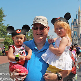 toddler and preschooler with grandfather at Disney World
