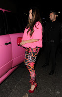 Katie Price dressed in pink standing in front of a pink car