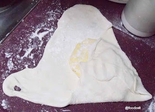 Folding the dough around the butter plate