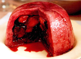 Autumn pudding of fruit in bread with a slice removed