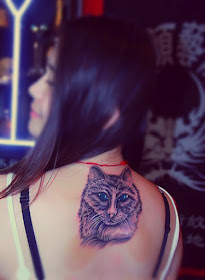 A vivid cat tattoo on the back 