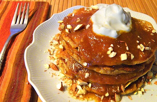 Layers of Pancakes and Persimmon Sauce Topped with Almonds and Yogurt Dollop