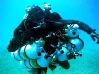 technical divers with lots of cylinders and equipment