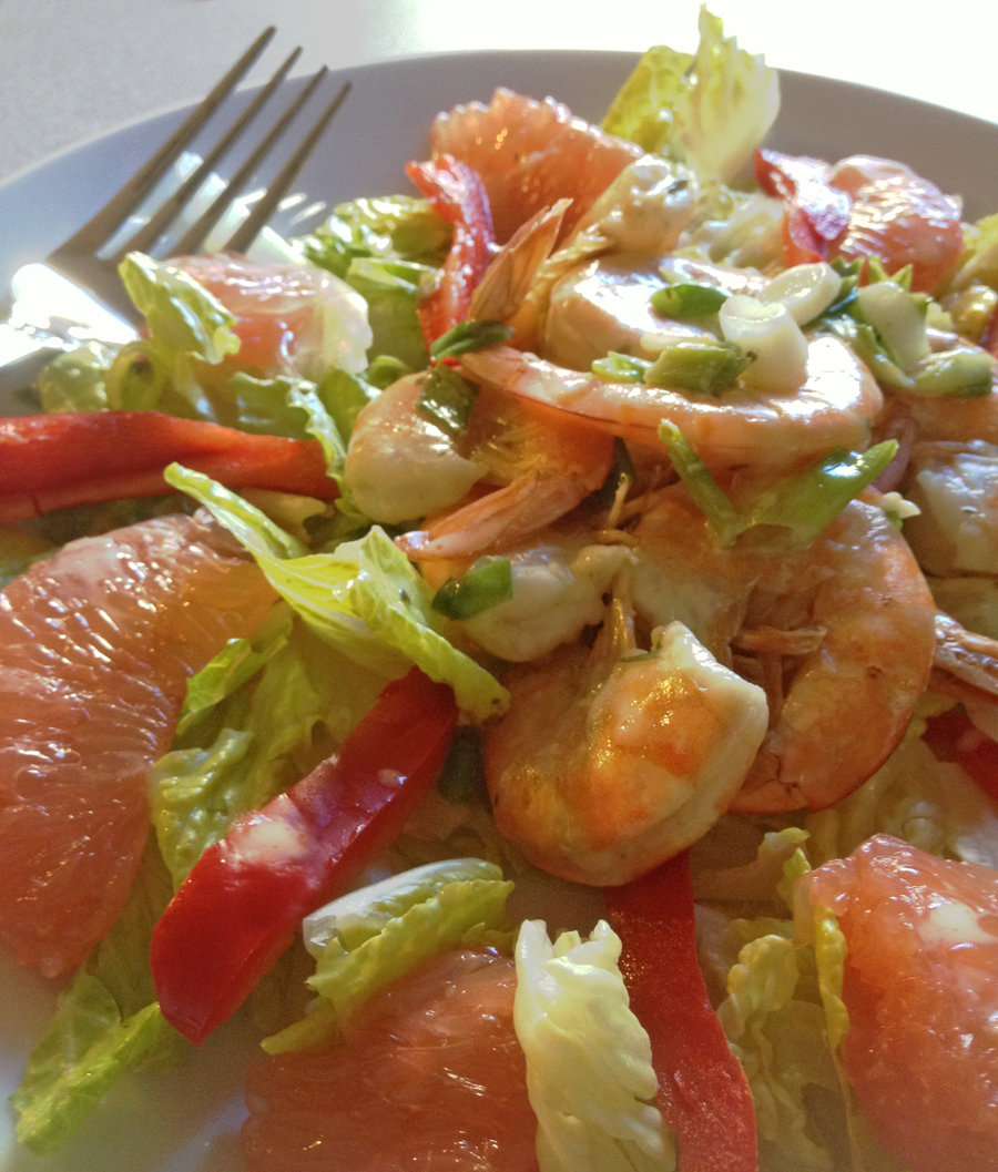 Image of Jalapeno Shrimp with Grapefruit Salad on a white plate with dressing drizzled over top