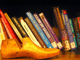 Vintage shoe last in front of a shelf of books at The Little Library in Melbourne Central.