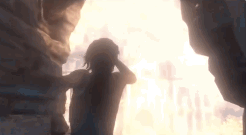 No gif: Cena do jogo Tomb Raider que mostra a protagonista saindo de uma caverna para a luz do lado de fora e conforme a claridade diminui ela enxerga as ruínas oponentes na base de uma montanha de um tom alaranjado de barro