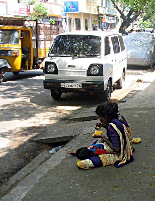 destitute eating on pavement
