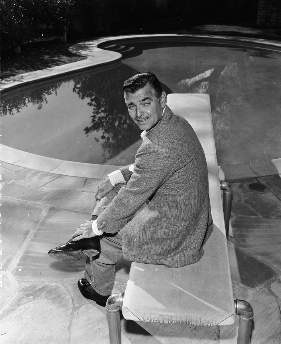 Clark Gable relaxing by his backyard pool at home in 1948