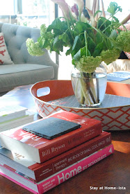 styling a coffee table with stacks of books- adds interest and color