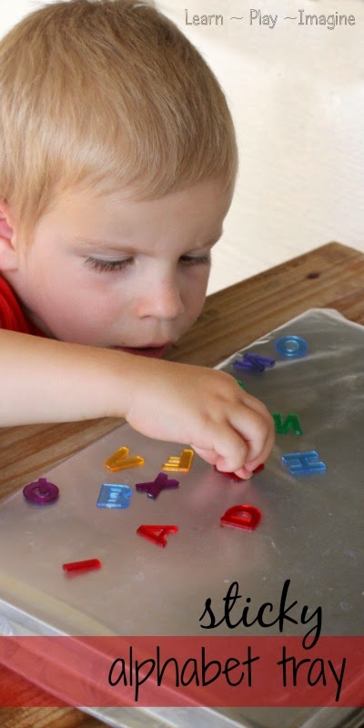 Learning the alphabet through play with a sticky alphabet tray.  Practice letter recognition with this sensory activity for preschool.