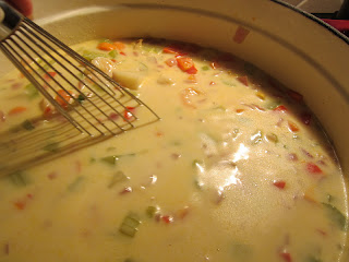 whisking chowder as it thickens