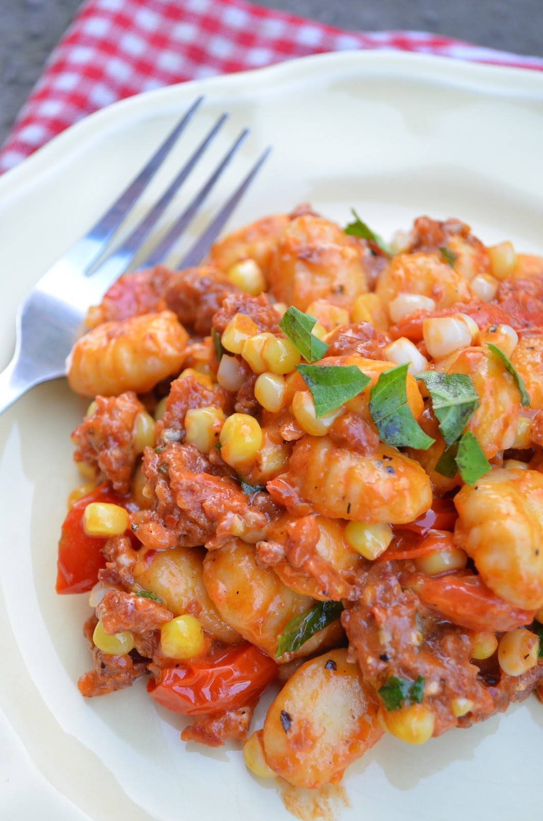 amour fou(d) gnocchi with spicy sausage, tomatoes, and corn.