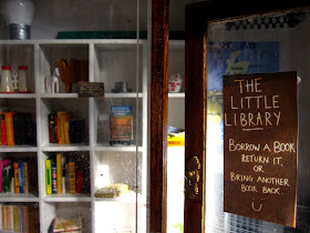 Entrance to a modern dolls' house miniature pop-up Little Library.