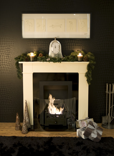 Traditional fireplace with a picture above it by Bio Fires