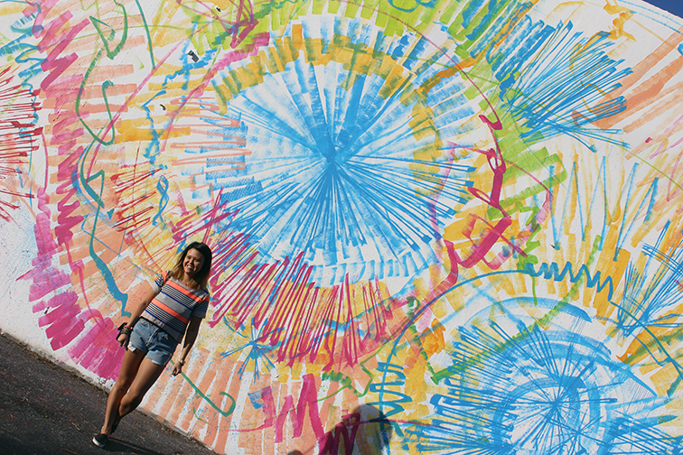 Lisa Tam from MIMO Market in front of a street art mural in Wynwood Lisa Tam from MIMO Market in front of a street art mural in Wynwood