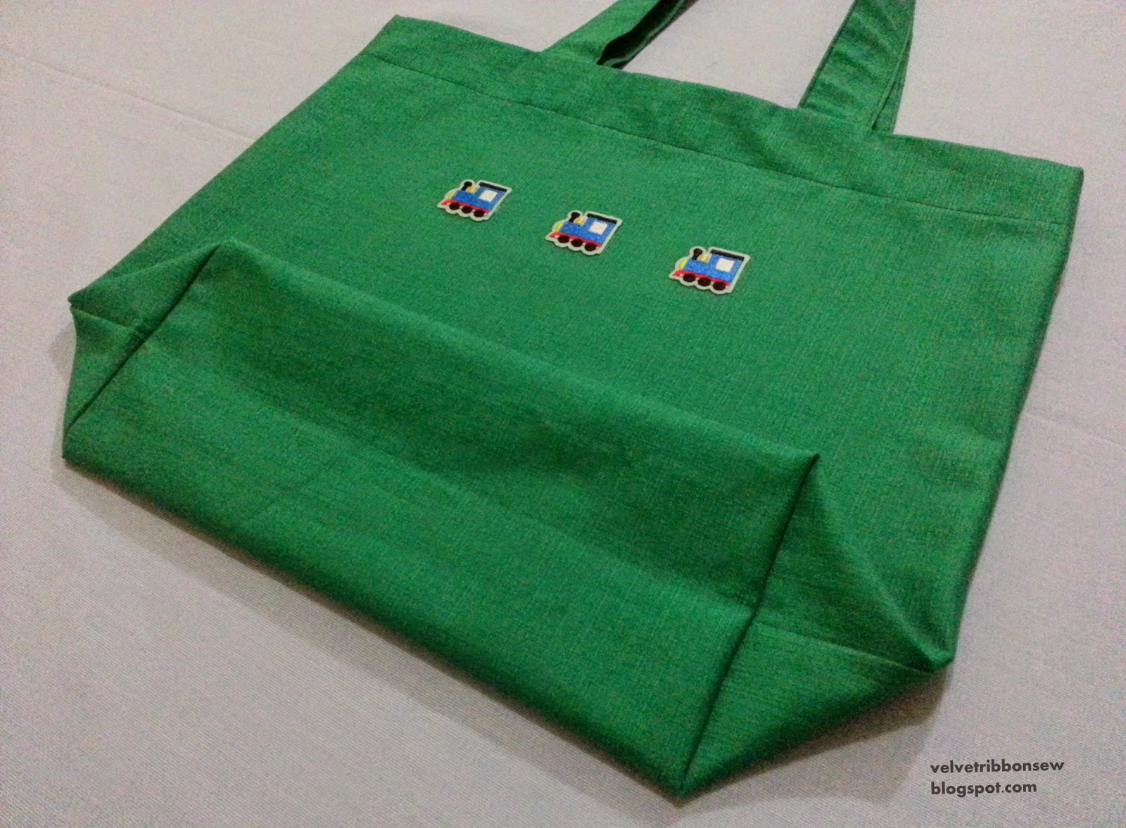 Green tote bag with trains