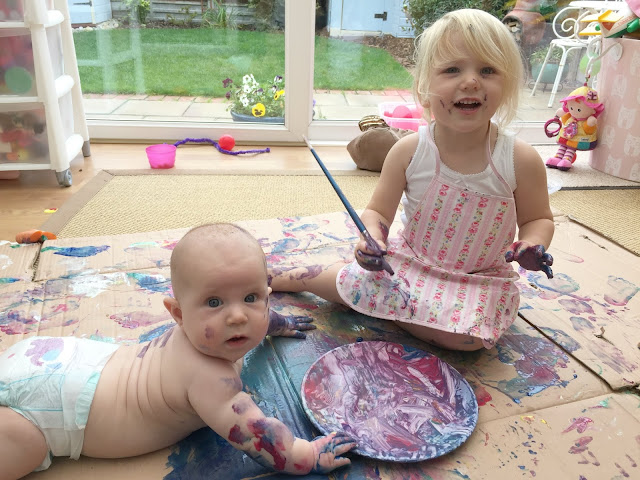 Tin Box Baby and Tin Box Tot covered in paint