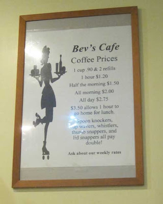 Bev's Cafe coffee price sign, $.90 per cup plus two refills, $1.20 per hour, $1.50 half morning, $2.00 all morning, $2.75 all day, $3.50 allows 1 hour to go home for lunch