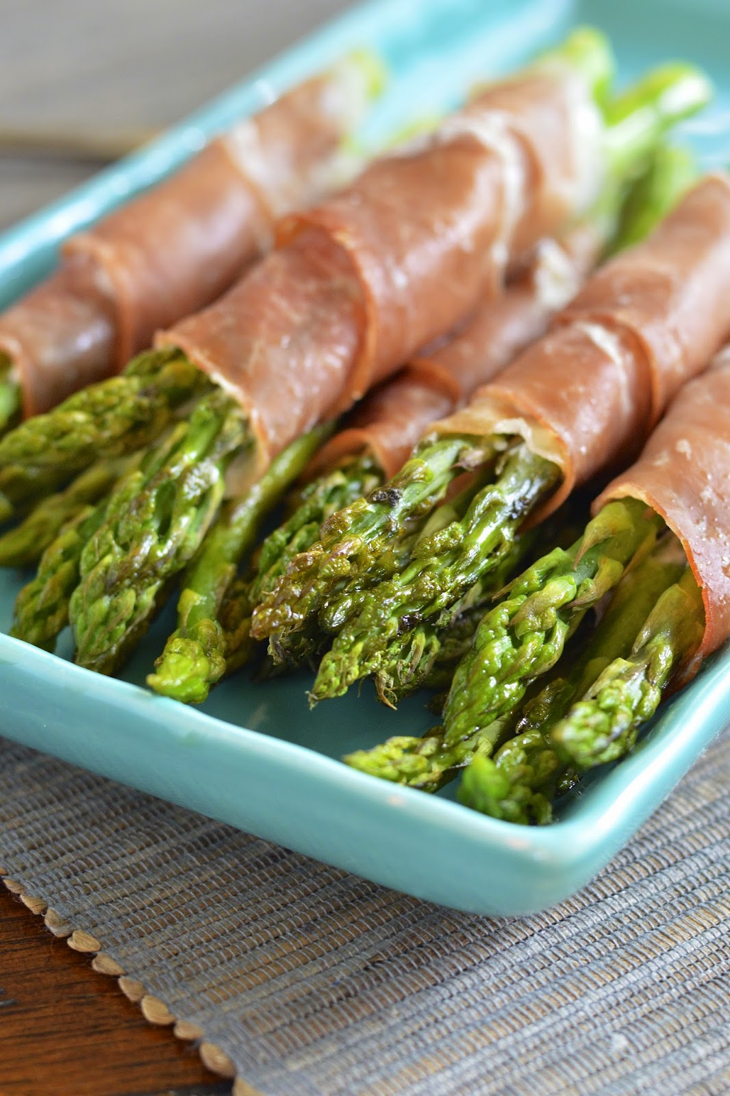 Bundles of asparagus wrapped in prosciutto, creamy goat cheese and a touch of garlic.