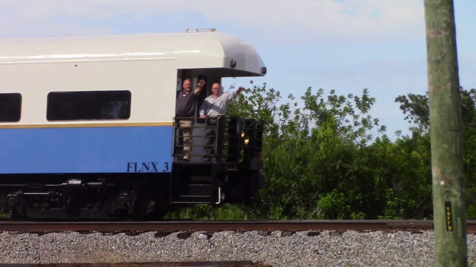 Road Foreman Engines Eric Usina and FEC General Manager John Williams wave from the St Augustine