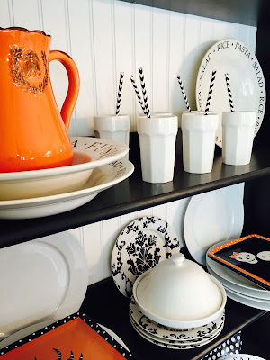 Fall decorated hutch, Ikea shelving, black and white dishes, Orange Halloween dishes
