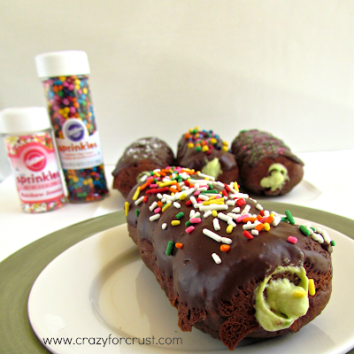 Chocolate twist doughnuts with avocado cream filling, plus sprinkles  on white plate 