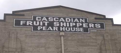 Angular concrete warehouse with classic vernacular sign reading Cascadian Fruit Shippers Pearhouse