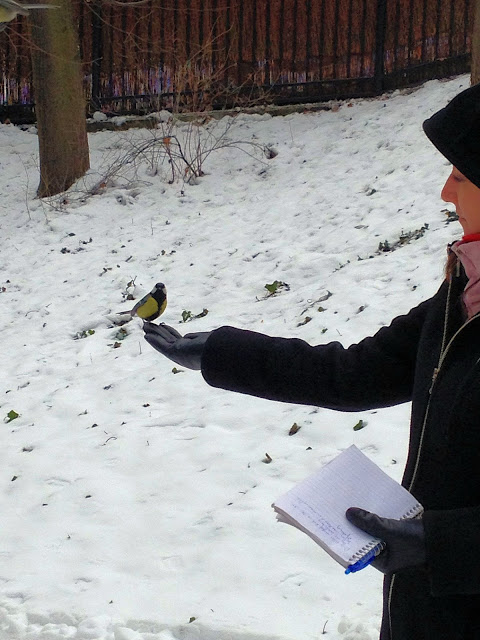 A touching photo of our author sharing a moment with one of the birds in Łazienki Park.