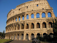 a close-up of a stone building with Colosseum in the background
