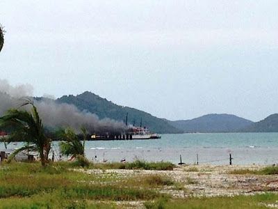 Raja ferry burning at the pier near Nathon