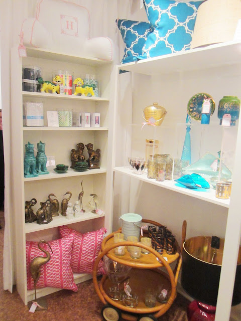 Nbaynadamas Pillows in pink and peacock blue on a white shelf surrounded by other vintage finds