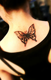 butterfly tattoo with black and white color on the back