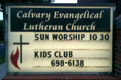 Lit letterboard sign that says SUN WORSHIP 10:30