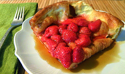 Slice of Pancake on Plate with Strawberries and Maple Syrup