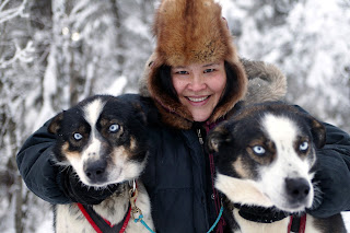 Evelyn Beeter with blue eyed huskies in Chistochina.