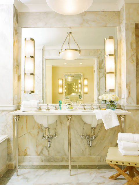 Bathroom in Kitchens and Baths by Michael S. Smith with marble walls, pendant light and wall mounted sink