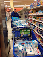 Mark behind a bunch of Carts with disaster relief supplies in them. 
