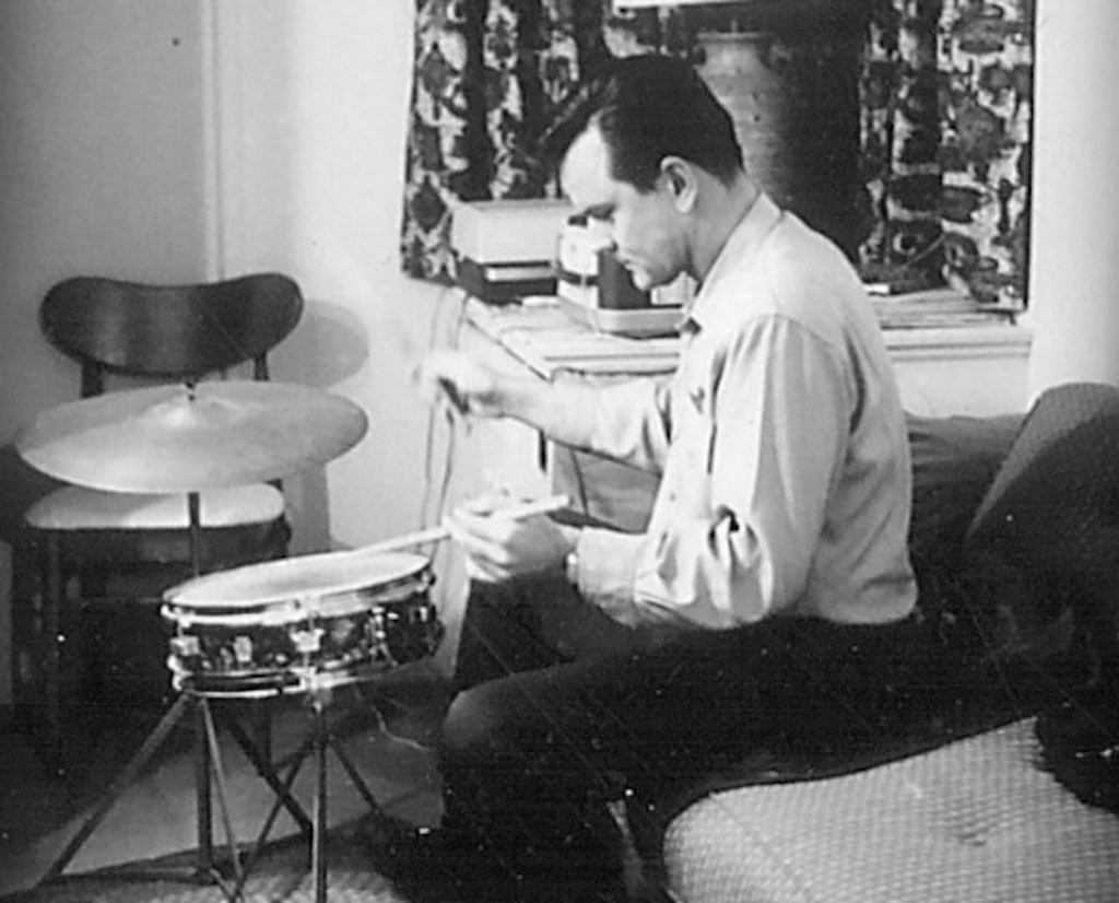 Bob Crane again at home drumming. 1960s.