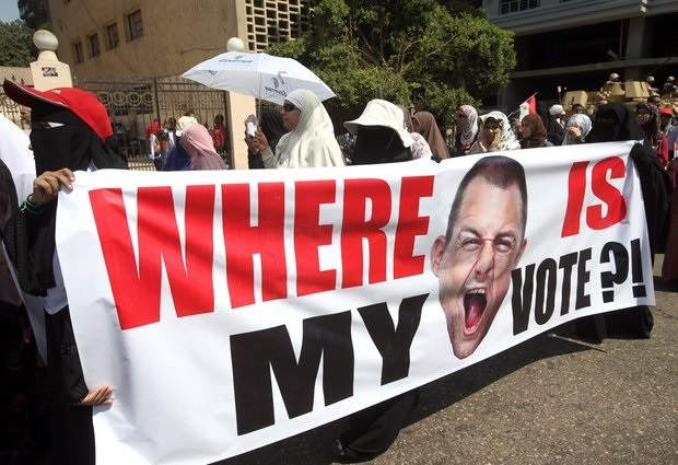 Photo: AP Supporters of ousted Egyptian President Mohammed Morsi carry a banner, as they march during a demonstration in front of the National Council for Human Right building in Cairo, Egypt, Sunday, July 21, 2013. Clashes between protesters and security forces have erupted into violence several times since Morsi's ouster, killing more than 60 people. The most recent incident occurred Friday night in the Nile Delta city of Mansoura when unidentified assailants opened fire at a Brotherhood-led march, sparking a melee that killed three female protesters, authorities said (think IN pictures @1WORLDCommunity)