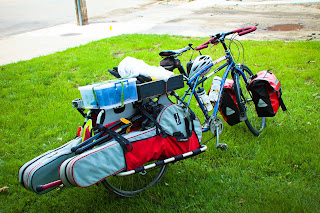 Trent's Xtracycle fully loaded with guitar, banjo, hatbox, stompbox, washer stick, and some clothes in the front panniers.