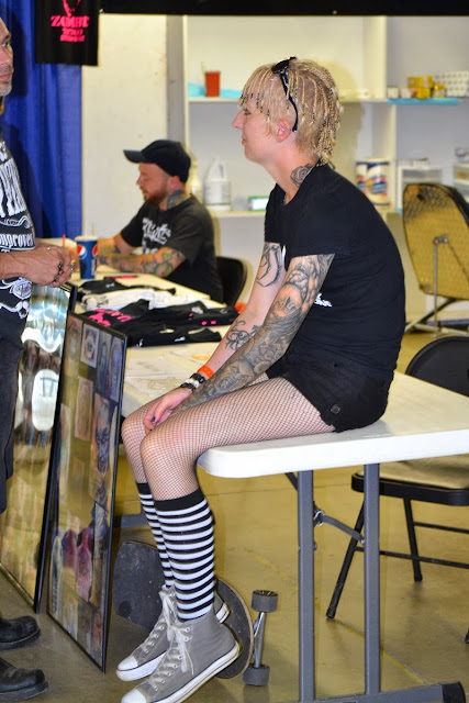 photo by Tom Storm - Raivyn dK - Easyriders Rodeo 2013 Chillicothe OH - tattoos - Fuxleep t-shirt, black shorts, fishnet stockings, Hot Topic socks, Converse sneakers