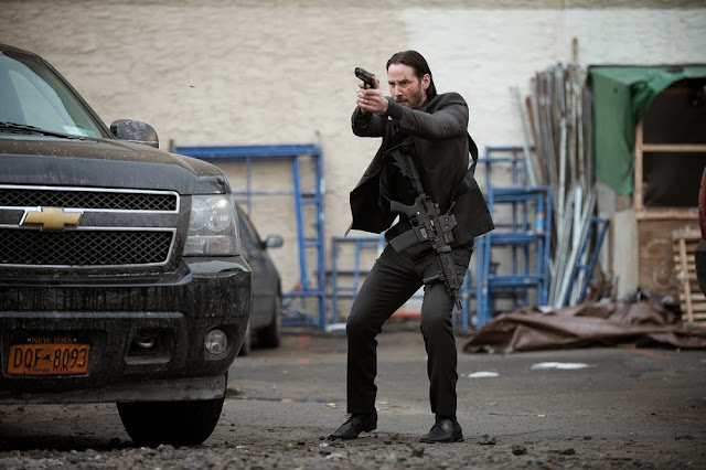 Keanu Reeves is John Wick in one of the many gun fight scenes. John Wick keanu reeves movie still