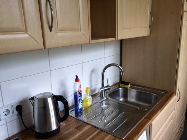 Küche mit Oberschränken und neuer Spüle