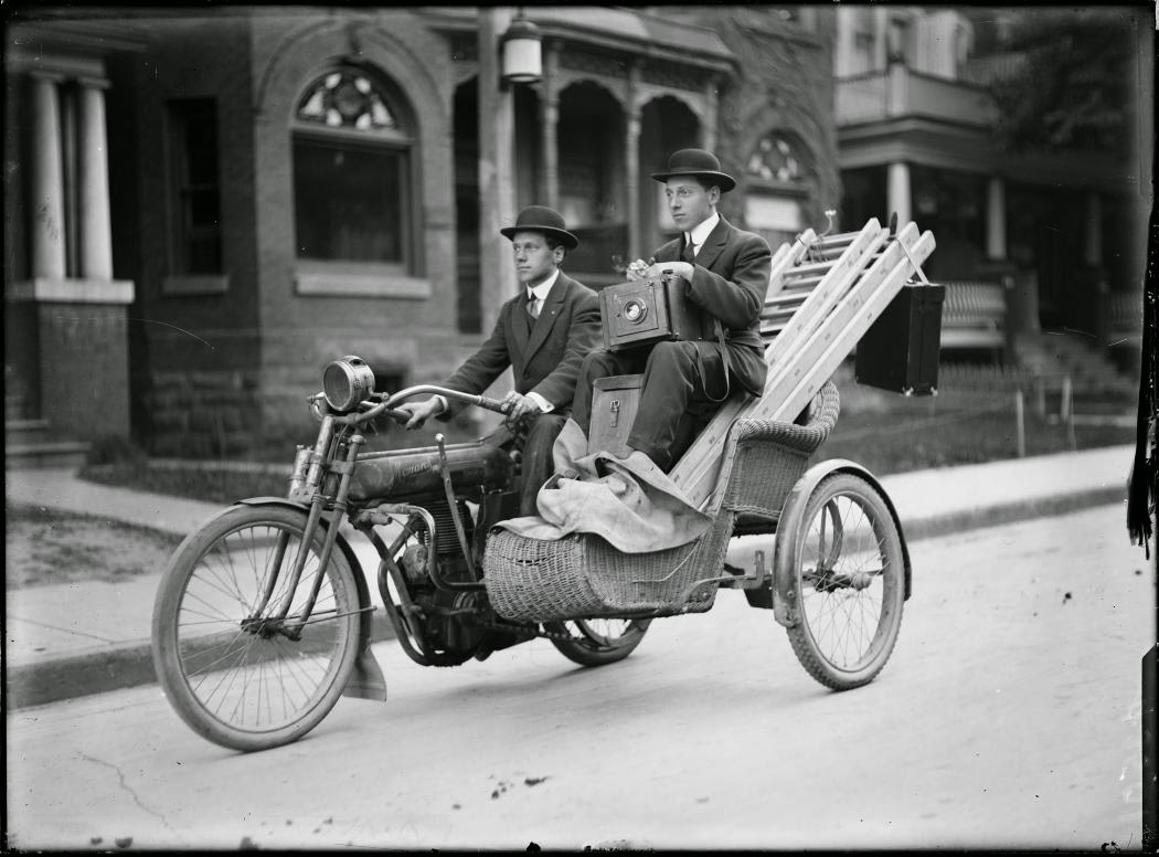 Photographers carry their equipment on a motorcycle in Toronto, 1912